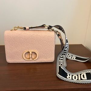 Pink purse with white & black straps.
